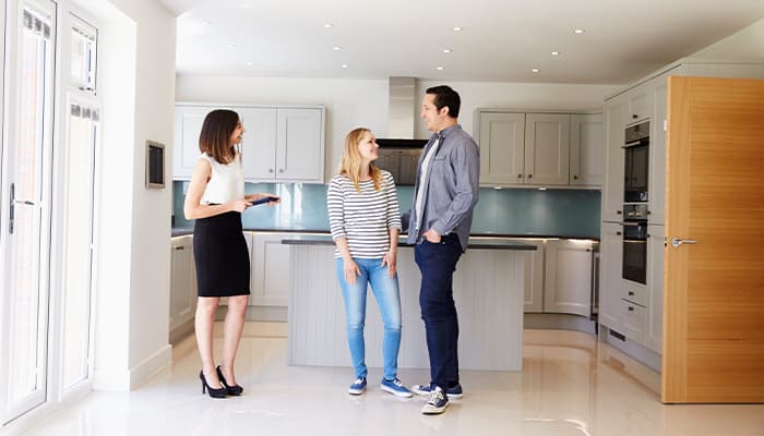 Couple viewing a property with an agent