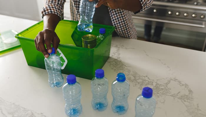 Man recycling to reduce his plastic waste