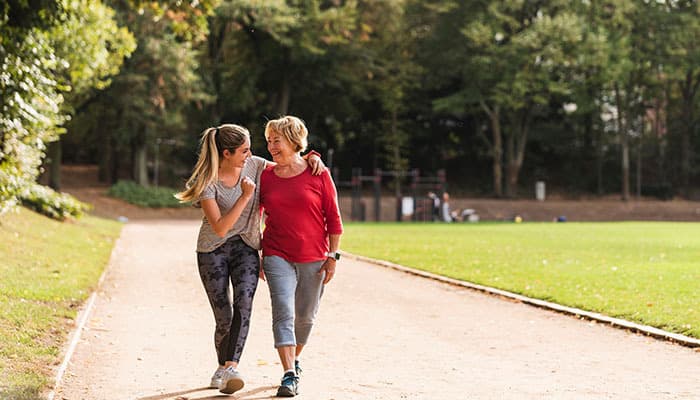 People walking through Shibden Park in Halifax