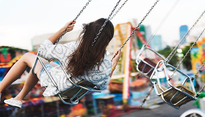 Woman riding a swing ride