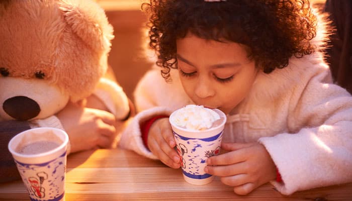 Little girl drinking hot chocolate